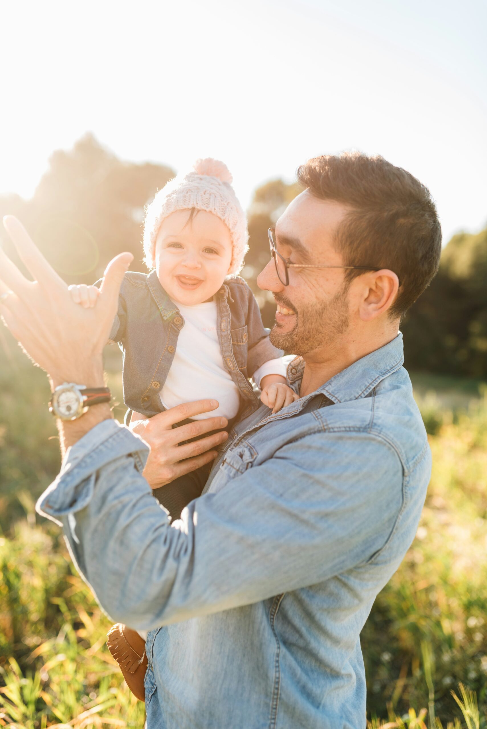 Man and Baby Happy and Playing in Sunshine