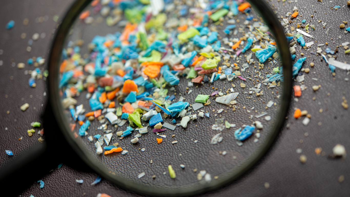 Magnifying glass showing micro-plastics